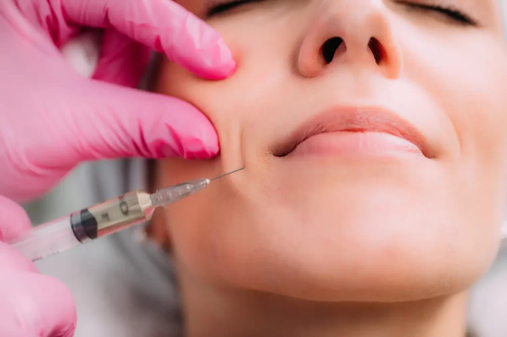 Close-up of a facial injection near the cheek during a dermal filler treatment