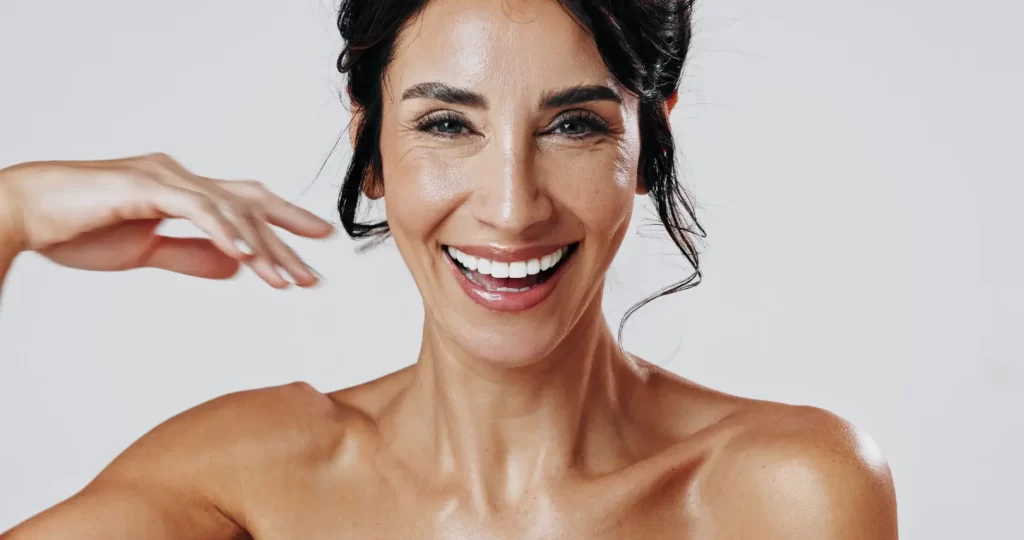Smiling mature woman with visible facial lines and natural skin texture
