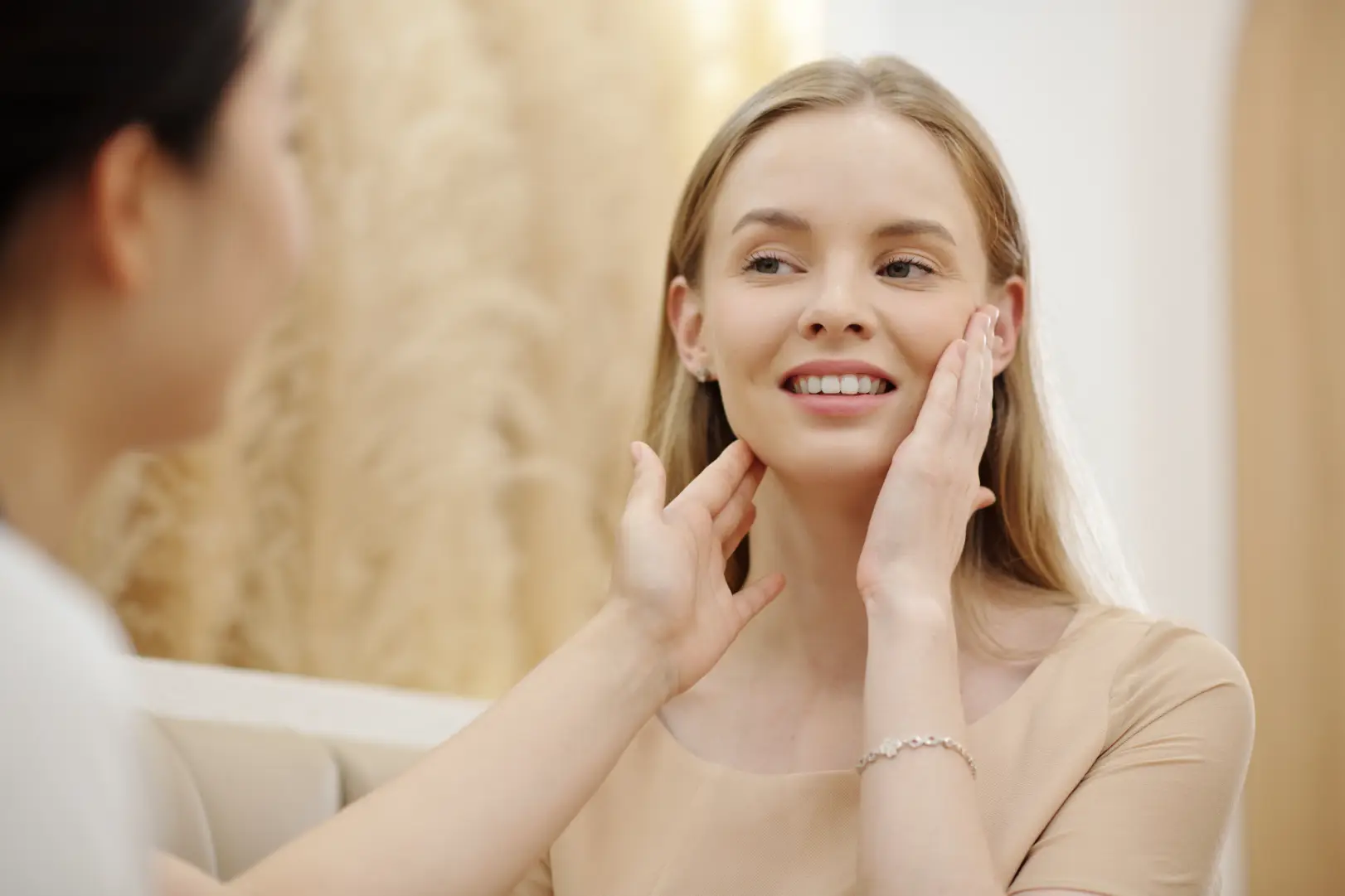 Woman touching her face during a med spa consultation with a provider